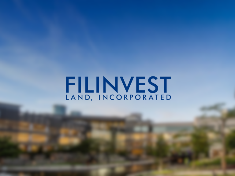 A blurred outdoor scene with a clear blue sky. In the foreground, the logo for FILINVEST LAND, INCORPORATED is displayed prominently in large blue letters. The background hints at multi-story buildings and greenery, creating a modern and professional atmosphere.