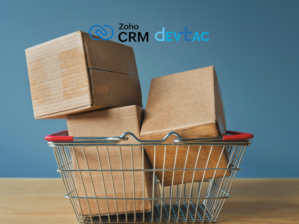 A metal shopping basket filled with stacked cardboard boxes, set against a blue background with Zoho CRM and Devtac logos.
