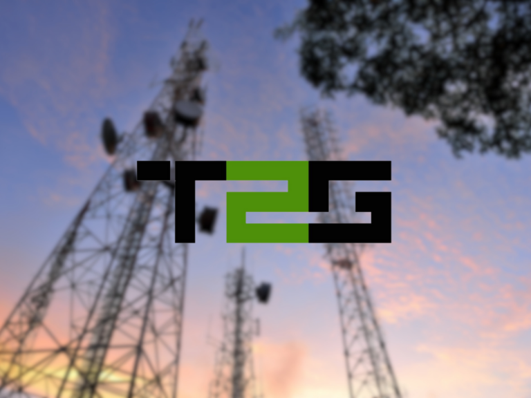 Blurry background of communication towers against a sunset sky, with a bold, stylized logo in the foreground. The logo features black rectangular shapes forming the letters ‘T2G’ with a green central element connecting the letters.