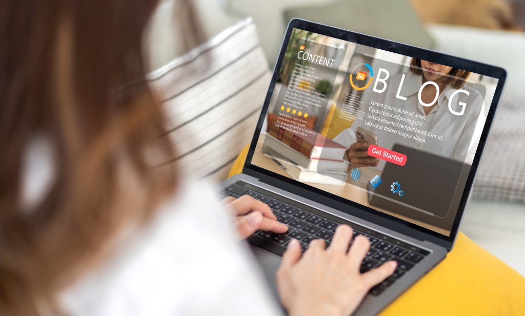 Zoho Social Guide: How to Manage Your Social Media Effectively a woman writing a blog on her laptop