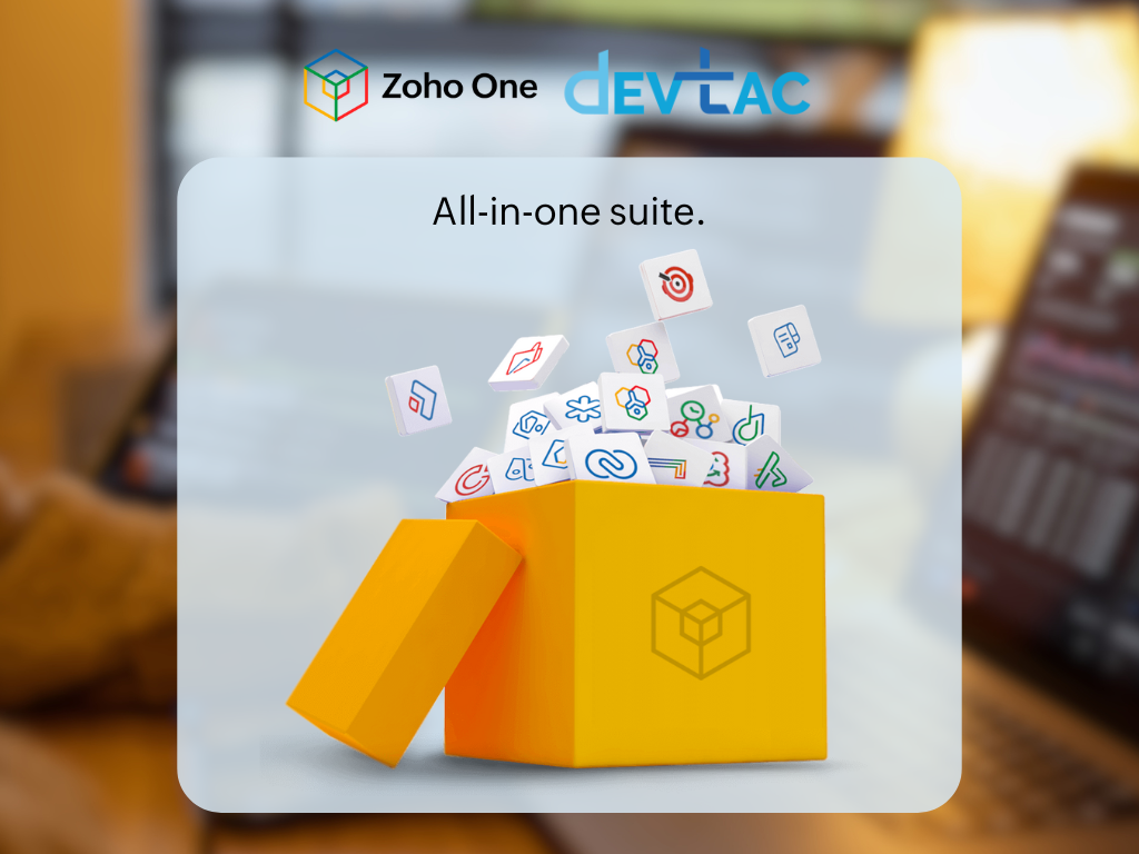 A bright yellow box with the lid partially open displays various colorful icons representing applications emerging from it. The background shows a blurred office setting with warm lighting. Above the box, the text reads "All-in-one suite," while the Zoho One and Devtac logos are positioned at the top.