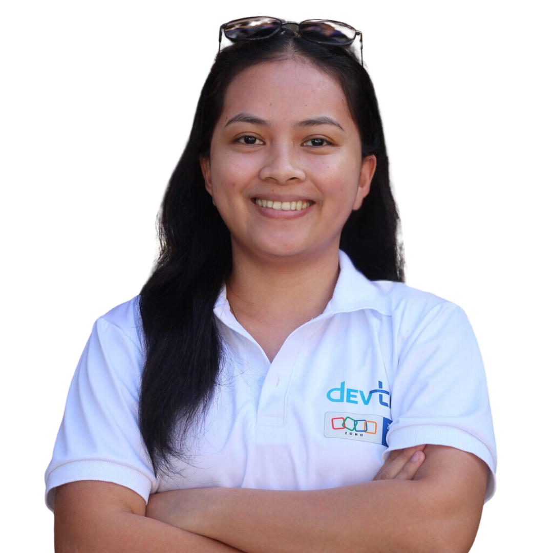 Devtac Team Portrait of a woman in a white polo shirt with DevTac logo, standing against a plain background