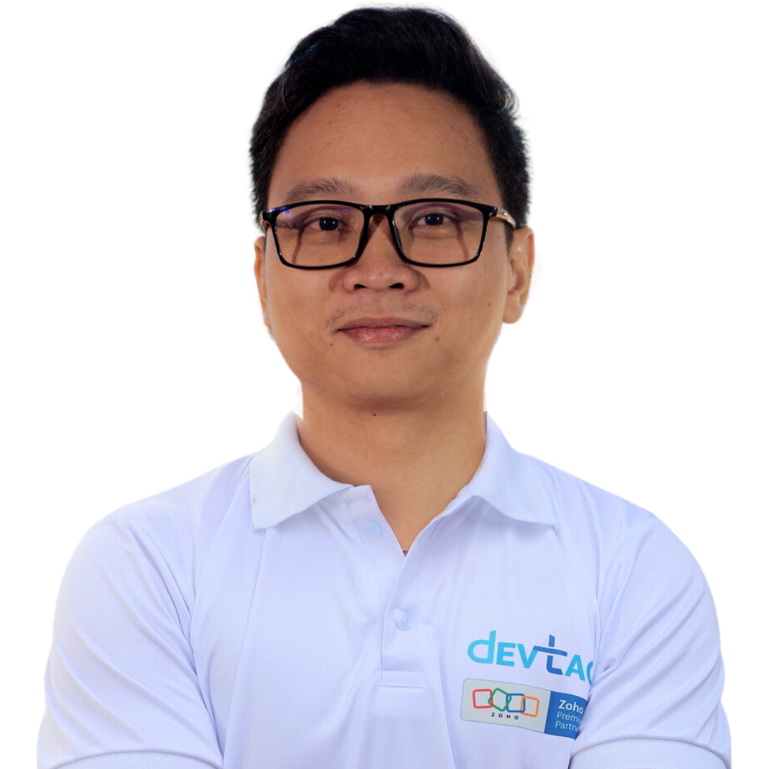 Devtac Team Portrait of a man in a white polo shirt with DevTac logo, standing against a plain background