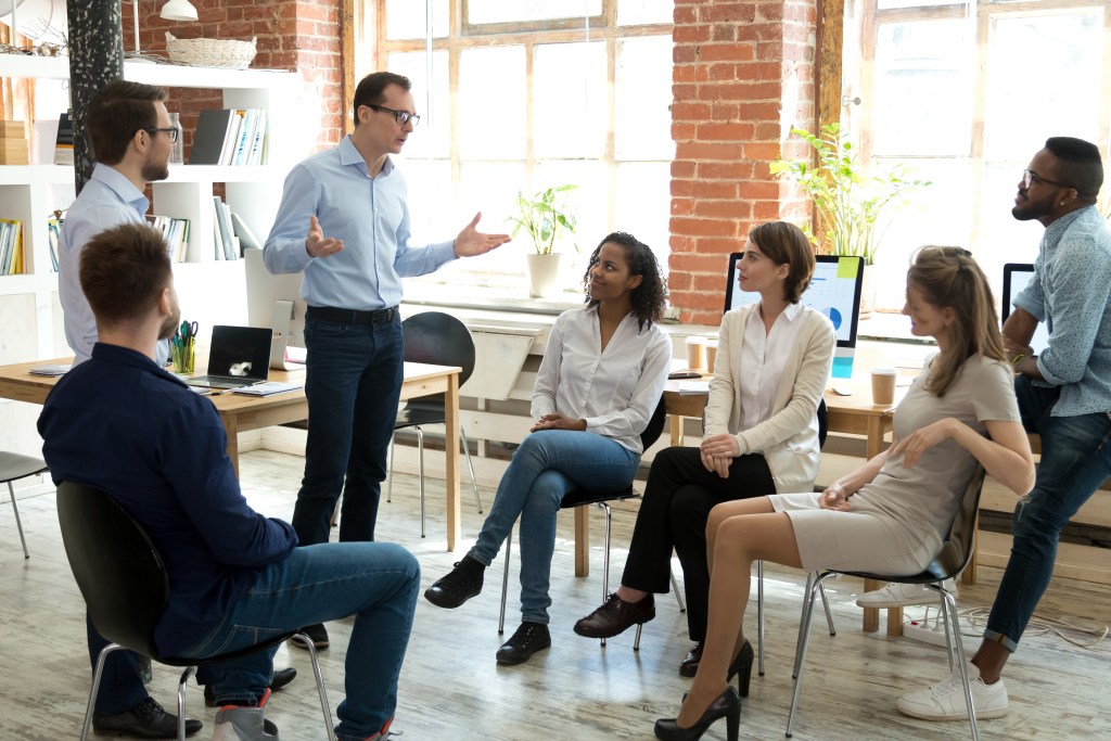 Unlock the Benefits of Zoho CRM Integration for Your Business colleagues having a discussion