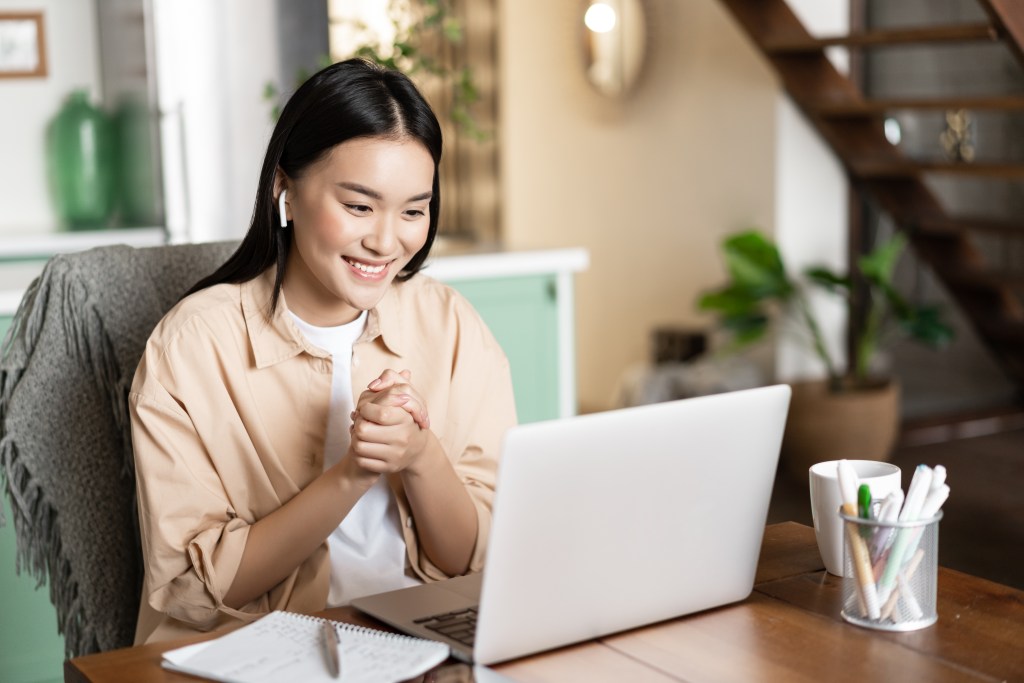 a young professional talking to someone on her laptop