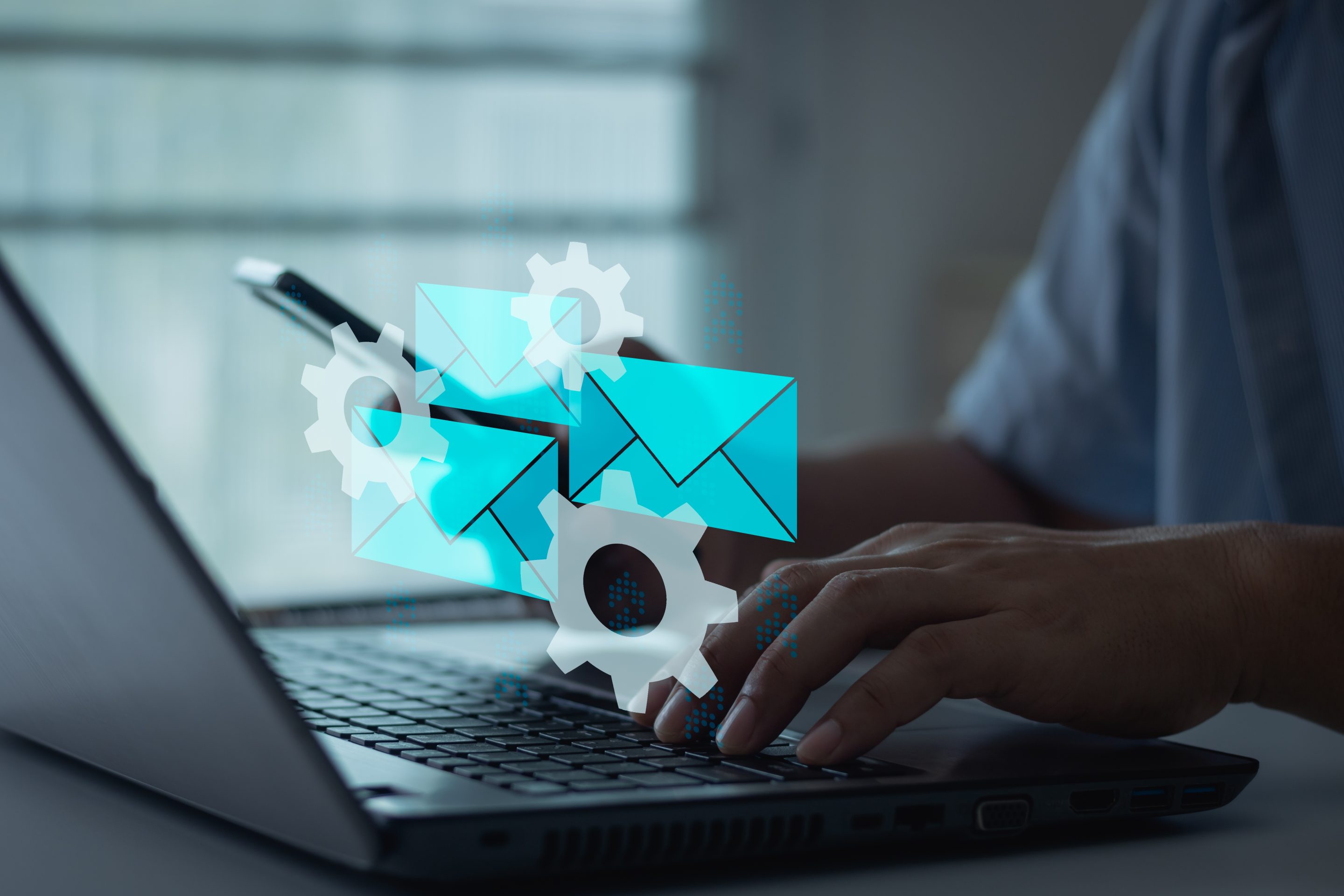 a man using a laptop with mail icons in front