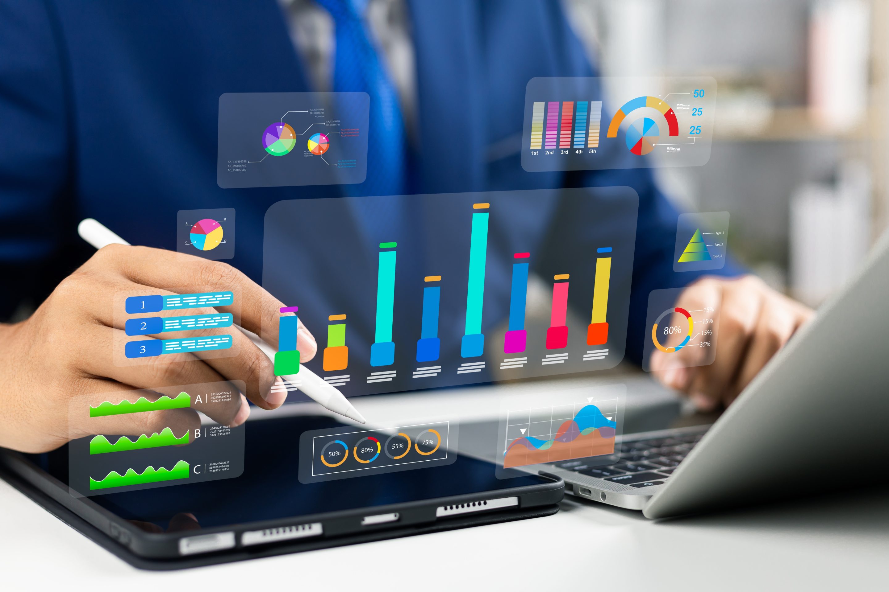 a man using a laptop with different graphs in front