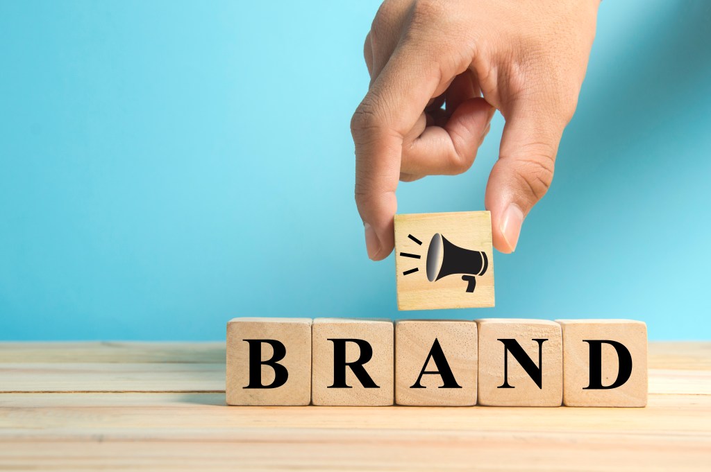 Solving Common Challenges in Sales and Marketing with CRM Solutions wooden cubes with the word 'brand' spelled out