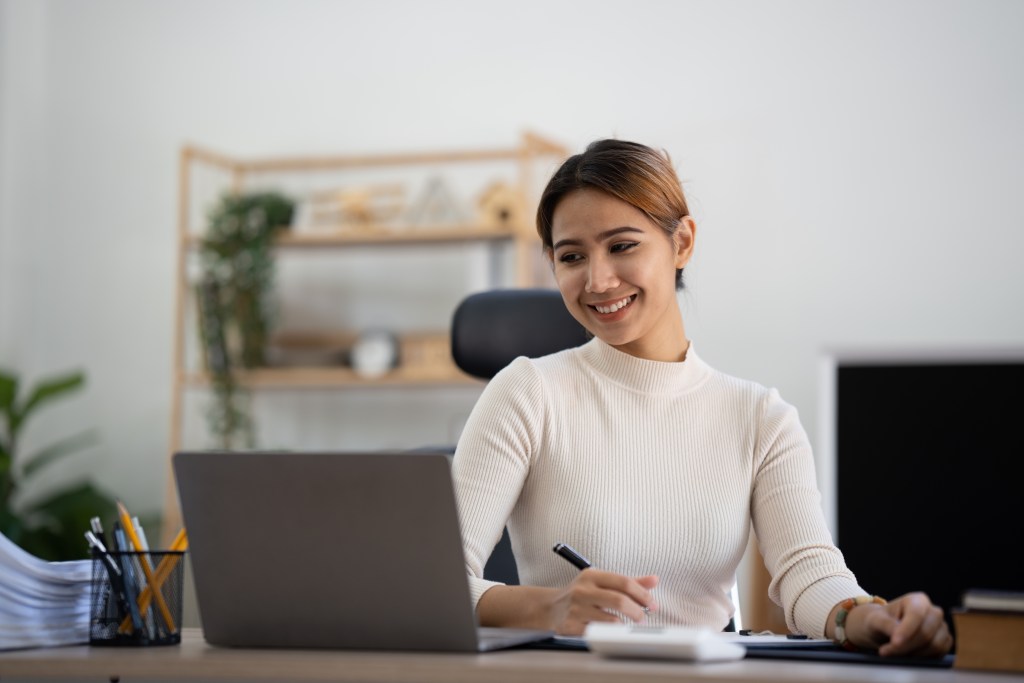 a businesswoman looking at her laptop