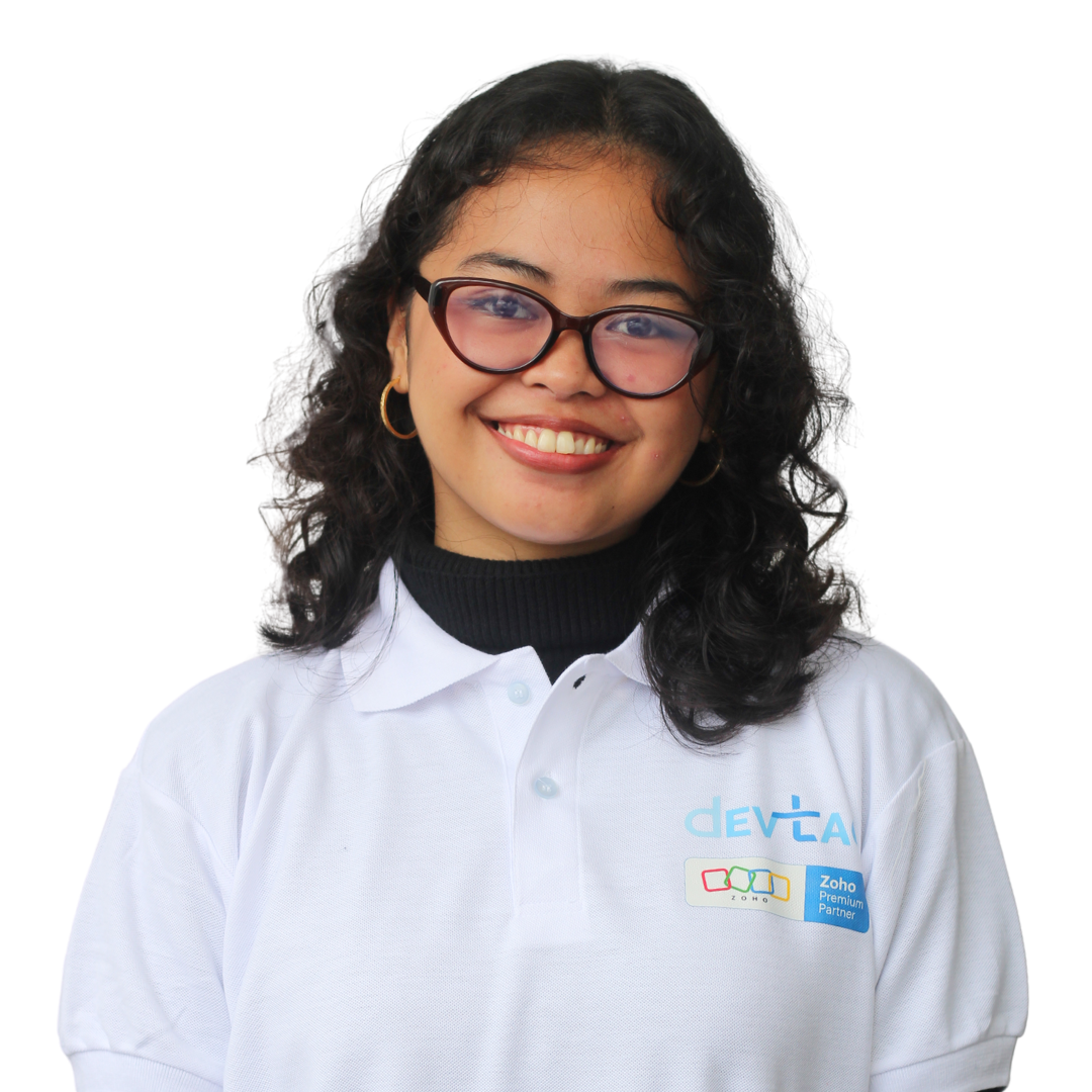 Devtac Team Portrait of a woman in a white polo shirt with DevTac logo, standing against a plain background