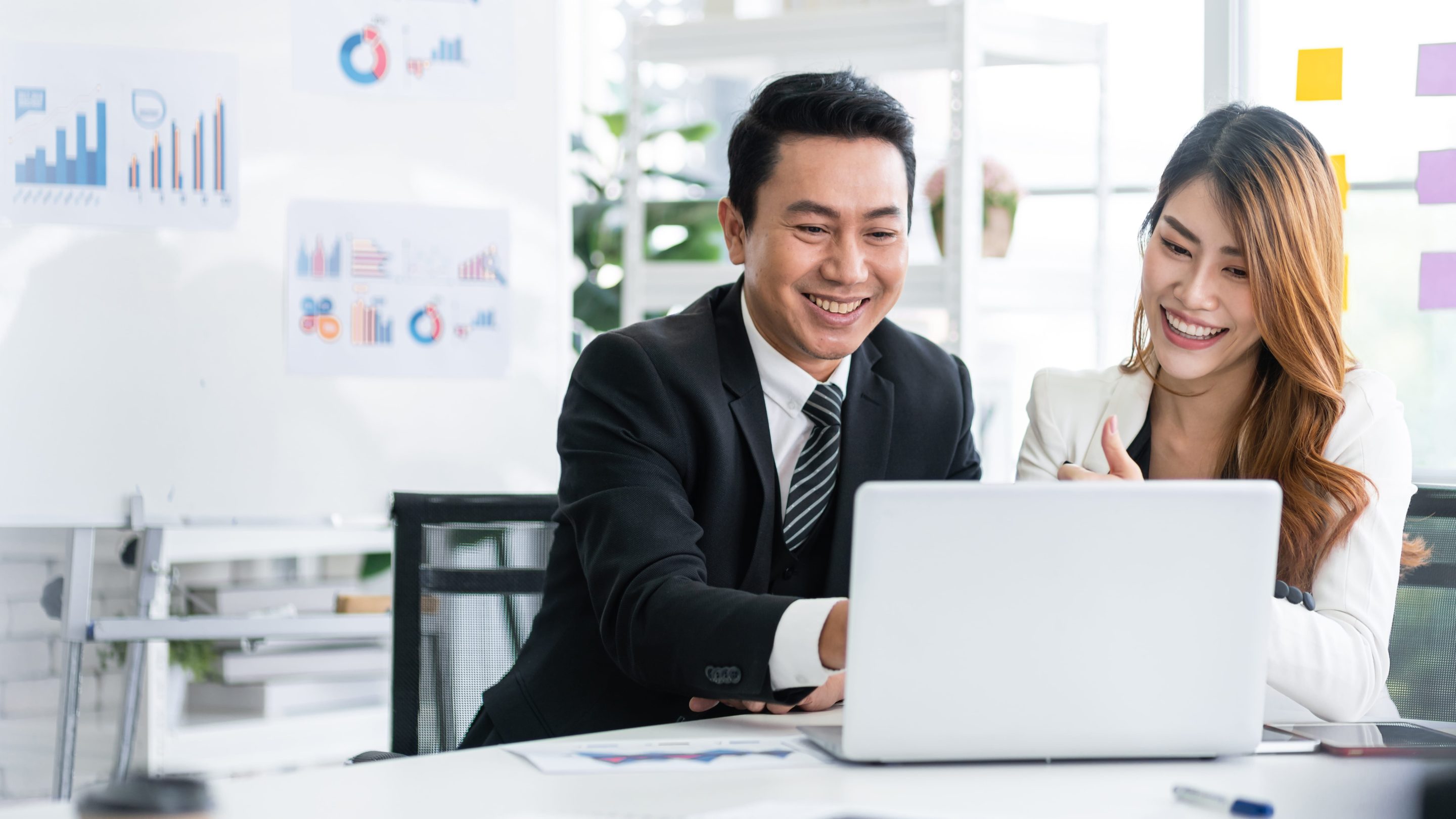 Sales professional looking at a laptop
