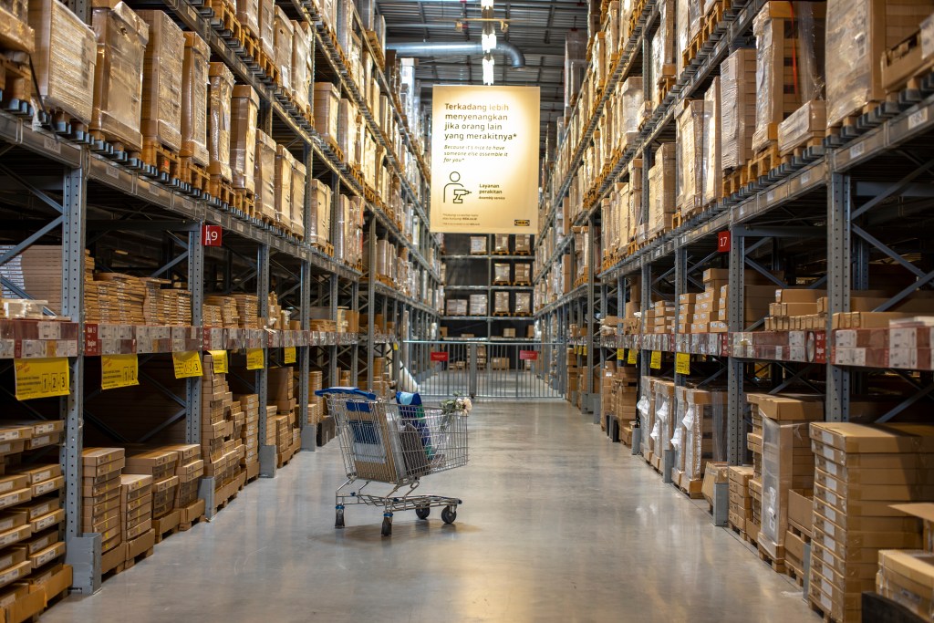 a trolley in the middle of two product racks