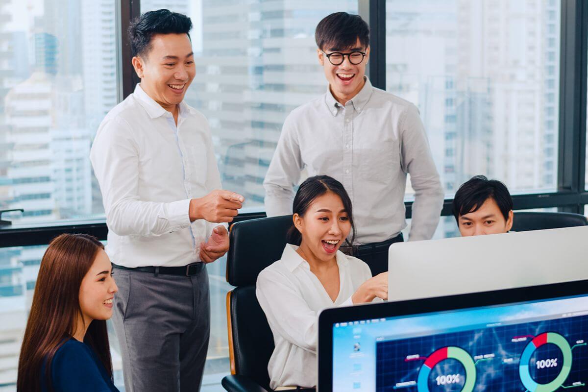 Business team reviewing digital dashboards, representing AI-powered access to business data within the Zoho ecosystem